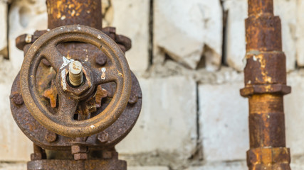 Old and rusty industrial pipe valve at power plant