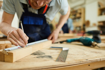 Mid section portrait of unrecognizable carpenter working with wood standing at table in workshop, copy space