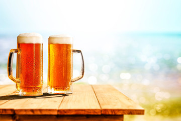 Cold beer in glass on wooden table and free space for your decoration. 