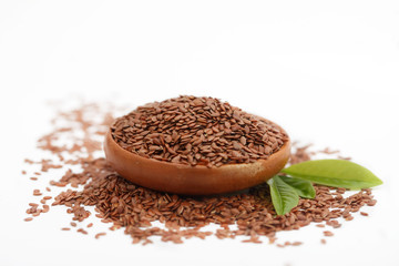 Brown flax seed or linseed in small bowl on white background. Healthy food.