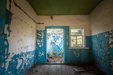 Blue interior of the kitchen of an abandoned house in Chernobyl exclusion zone in Belarus