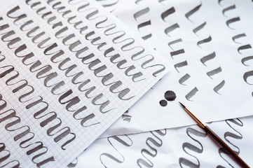 Letters train background and calligraphy pen paper. Learning calligraphy