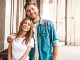 Portrait of smiling beautiful girl and her handsome boyfriend. Woman in casual summer jeans clothes. Happy cheerful family. Female having fun on the street background. Hugging