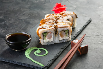 roll with eel and shrimp on a black stone background