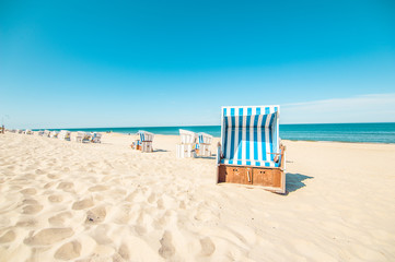 Beach in Westerland with the typical german roofed beach chairs or "Strandkorb" and white sand, Sylt island, North Sea, Germany