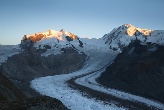 Last sunlight on the Monte Rosa mountain massif. Gornergrat, Zermatt, Switzerland.