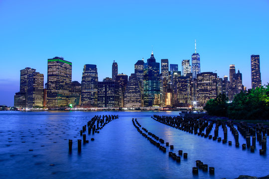 Manhattan panoramic skyline at night from Brooklyn Bridge Park. New York City