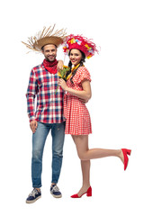 happy man and young woman in festive clothes with sunflowers isolated on white