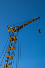 Construction crane against the blue sky