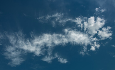 Naklejka na ściany i meble Cloud dragon against the background of the deep blue sky