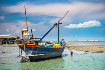 Fototapeta na wymiar Fishery wooden boat at the shore seascape.