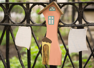 wooden figure of house and few blank wooden signs