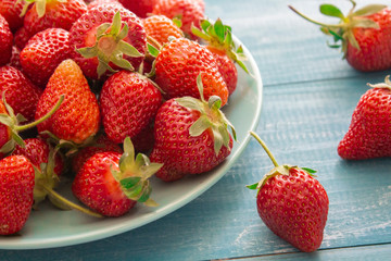 Fresh strawberries. Strawberry background. Macro texture. big, big strawberries. On a blue background. Harvesting clean local strawberries.
