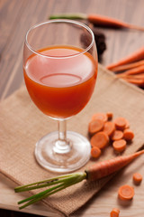Glasses of carrot juice on sack