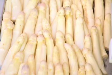 Organic white asparagus with selective focus. New eco harvest, white asparagus. Bunch of fresh ripe asparagus. Asparagus on the market stall. Dietary low-calorie vegetable. Seasonal vegetables 
