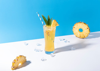 iced pineapple punch cocktail in glass on color background. summer drink.