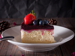 Blueberry cheesecake decorate with pinecorn and dry flower on wood board