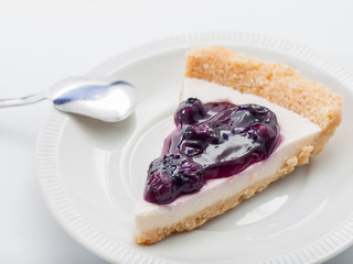 blue berry cheesecake on white background