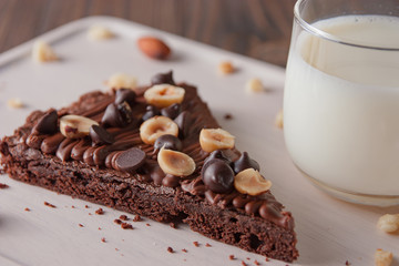 chocolate cake with marshmallows , cut on wooden board