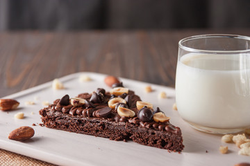chocolate cake with marshmallows , cut on wooden board