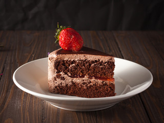 Chocolate strawberry cake on wood boad