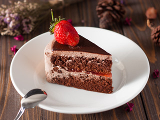 Chocolate strawberry cake on wood boad