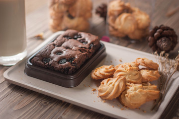 chocolate brownie and cookies on wood background