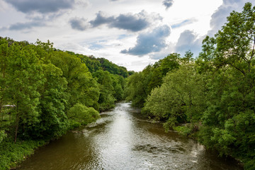 Fototapeta na wymiar View on the river Jagst flowing between trees in Neudenau, Germany. 