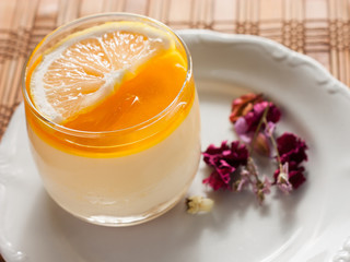 lemon cheesecake in glass on wood background