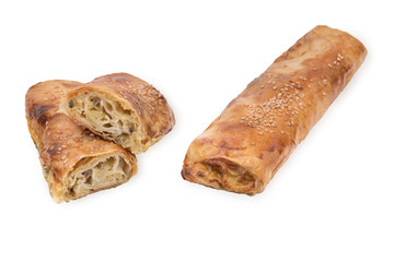 Baking puff pastry with potatoes and mushrooms, one pastry in the cut. Isolated on white background