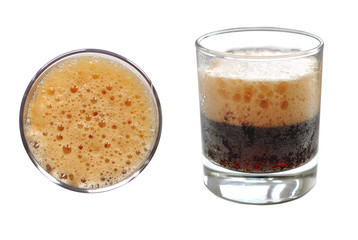 Dark cold carbonated drink with foam in glass Cup on white background