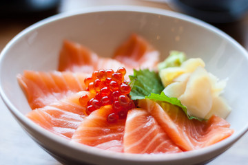 salmon sashimi put into white bowl