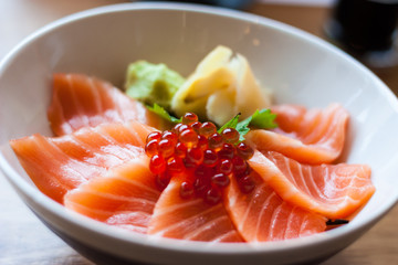 salmon sashimi put into white bowl