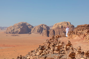 Bedouin and Panoramic view of the Red Desert in Wadi Rum, Jordan, Middle East.