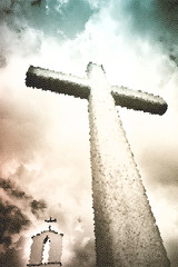 Concrete christian cross against a dramatic cloudy sky - art concept image