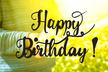 English Calligraphy Happy Birthday. Cute Little Kid Is Holding A Bouquet Of Daisy Flower. Sunny And Spring Flower Field.