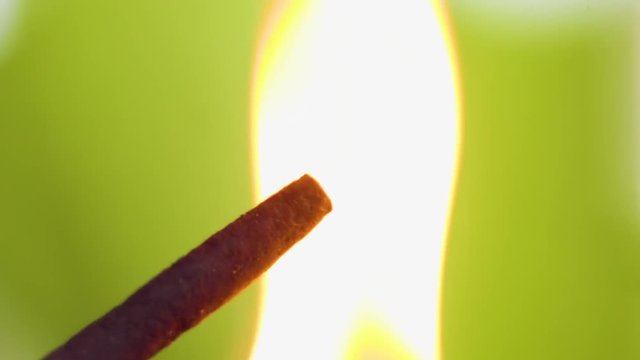 Incense smoke close-up. Match firing aroma stick. Tranquility and mindfulness.