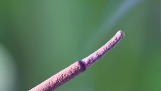 Incense smoke close-up. Match firing aroma stick. Tranquility and mindfulness.