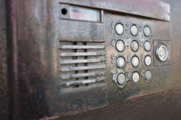 Old vintage intercom on apartment building doors