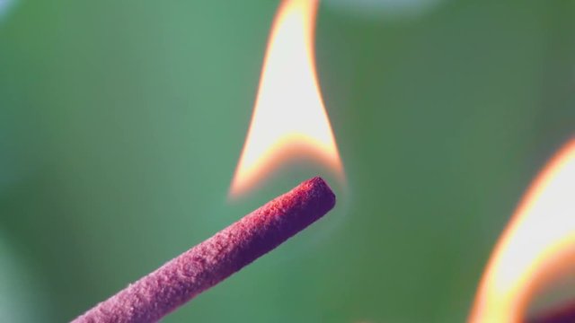 Incense smoke close-up. Match firing aroma stick. Tranquility and mindfulness.