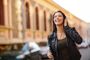 Young woman enjoys music on the street