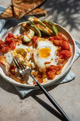 Tasty and Healthy Shakshuka. Eggs Poached in Spicy Tomato Pepper Sauce.