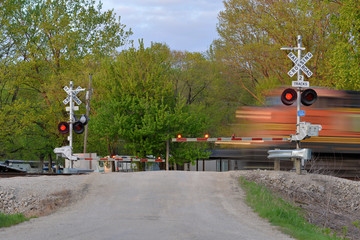 Freight train blurred  in motion at crossing gate © dvande