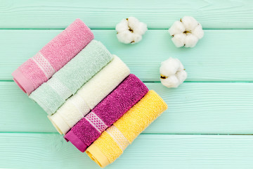 high quality cotton towels set on mint green wooden background top view