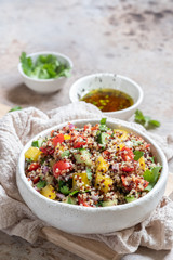 Fresh quinoa tabbouleh salad with tomatoes, peppers and cucumbers