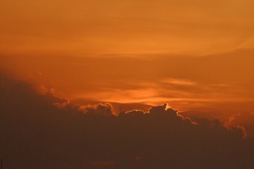 Silhouette sunset with orange sky with clouds at dusk