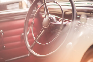 Classic vintage car interior, close up on steering wheel, dasboard, retro effect