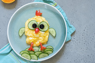 Funny chick egg omelette with vegetables for kids breakfast