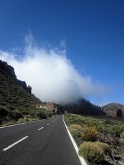 Beauty of the nature - phenomenal cloud hanging over the asphalt road in Teide National Park....
