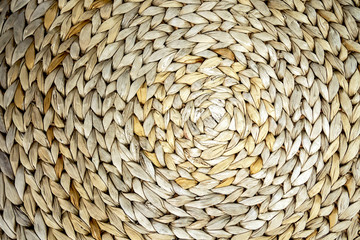 textured background of a circle seaweed woven pattern, close-up backdrop